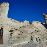 A hiker by the spires in Resurrection Canyon, Glen Canyon National Recreation Area, Utah